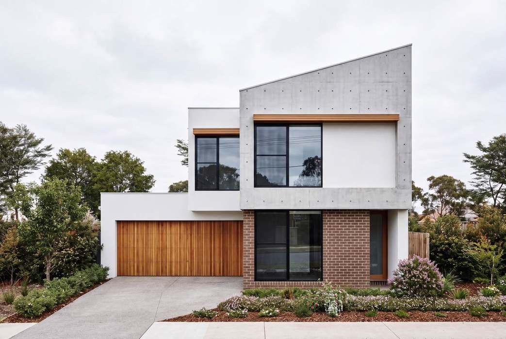 Two-storey house facade, brick and timber garage